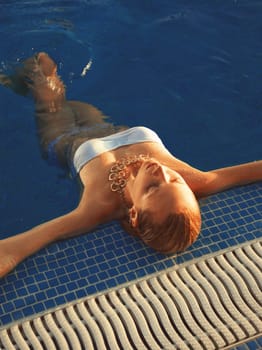 Girl relaxing in swimming pool