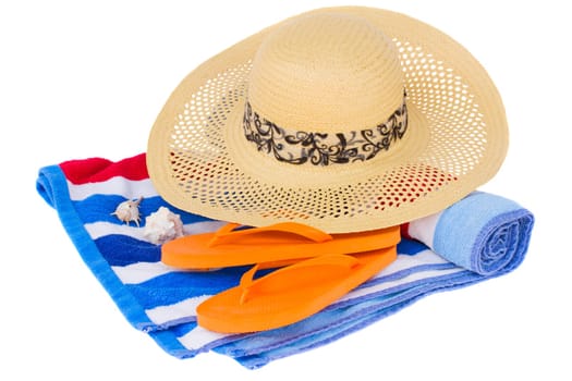 straw hat and beach towel isolated on white background