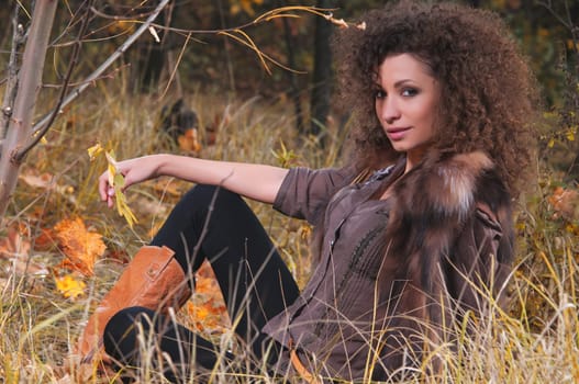 Portrait of a hot young woman in autumn park