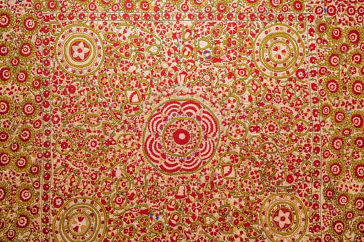 traditional Uzbek pattern on an ancient handmade carpet in Uzbekistan. Oriental background with beautiful ornaments