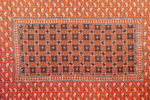 traditional Uzbek geometric pattern on an ancient vintage carpet in Uzbekistan. Oriental background with beautiful ornaments