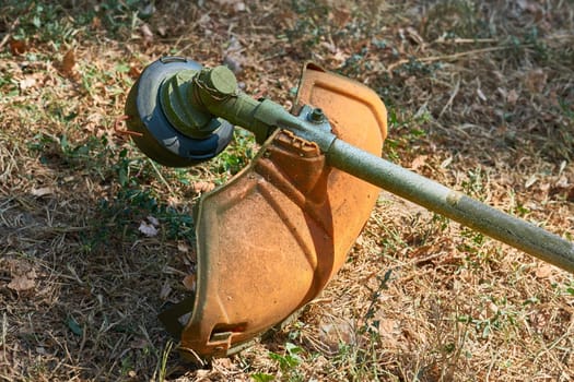 a handle electric or gasoline machine for cutting the grass on a lawn