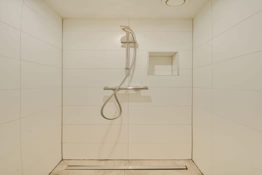This image features a sleek, minimalist shower design with clean lines, a modern showerhead, and simple tile work, showcasing contemporary bathroom aesthetics.
