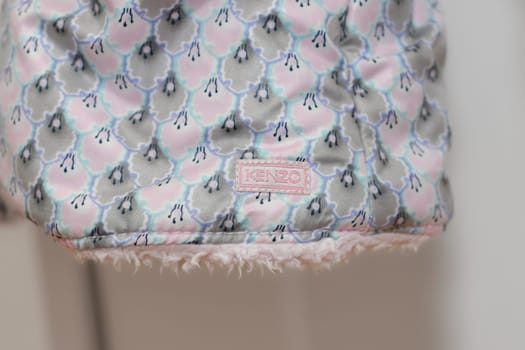 PARIS - FRANCE - 05 March 2023 - Kenzo label on a pink jacket for a girl. A luxury fashion brand
