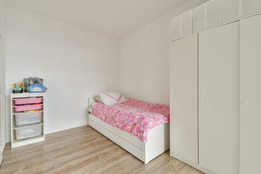 A minimalist child's bedroom featuring light walls, a single bed with colorful bedding, and simple storage solutions for toys and essentials.