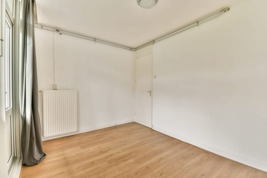 An empty room showcasing minimalist design with light-colored walls and wooden flooring, emphasizing simplicity and space. Perfect for modern home aesthetics.