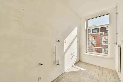 Bright and airy room featuring a large window. The space is designed with a minimalist aesthetic, showcasing the potential for modern interiors.