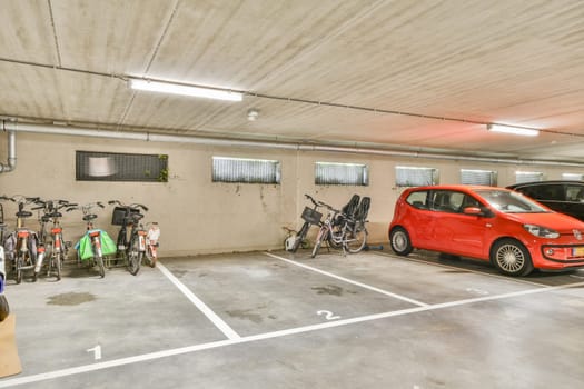 A well-organized urban parking area featuring several bicycles along with parked cars, showcasing efficient use of space in a commercial setting.