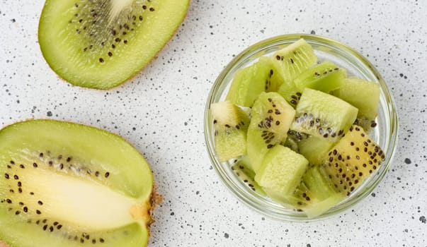 Diced kiwi in glass bowl, top view