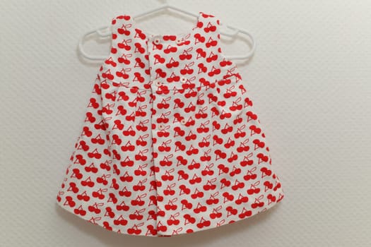 Dress with cherry patterns for girls on white background