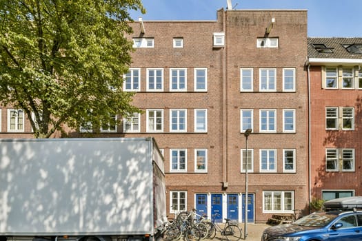 A modern urban building display features large windows and a brick facade with bicycles parked in front, embodying contemporary city life.