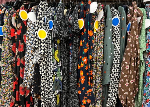 Dresses with different motifs at a consignment shop on sale in shop