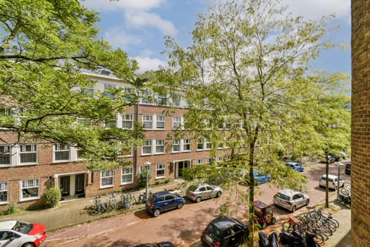 A vibrant urban landscape showcasing trees lining a street filled with parked bicycles and cars under a clear sky, exemplifying city life and nature's blend.