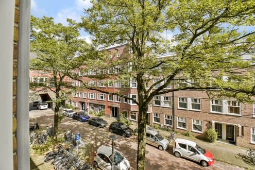 A vibrant urban scene showcasing trees, parked vehicles, and residential buildings, highlighting the blend of nature and city life.
