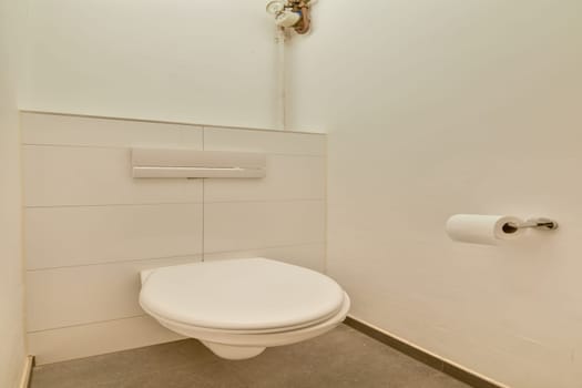 A sleek and modern toilet setup in a minimalist bathroom design, featuring clean lines and neutral tones, ideal for contemporary spaces.