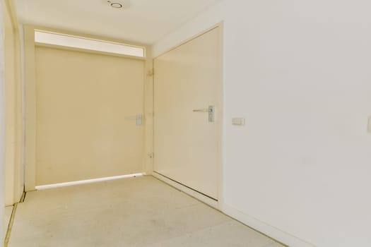 A clean and simple design showcases a modern interior doorway, emphasizing minimalism with neutral colors and soft lighting in this spacious hallway.