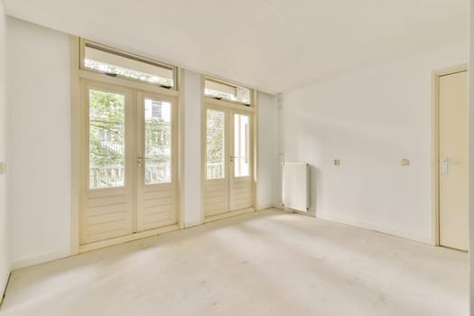 A spacious, bright, and minimalist interior featuring large windows that invite natural light. The clean lines and uncluttered design promote a serene ambiance.