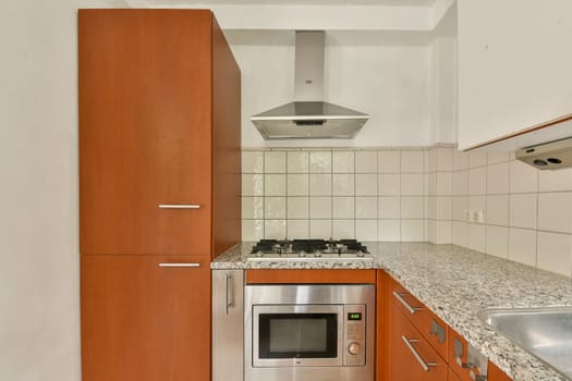 A contemporary kitchen featuring sleek cabinetry, a stainless steel oven, and a stylish cooktop, creating an inviting cooking space.