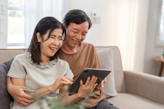 A retired couple relaxes in their living room, enjoying a comfortable and peaceful lifestyle with modern decor and natural light.
