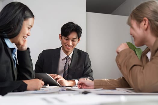 A diverse group of professionals collaborating in a modern office, discussing strategies and ideas during a business meeting.