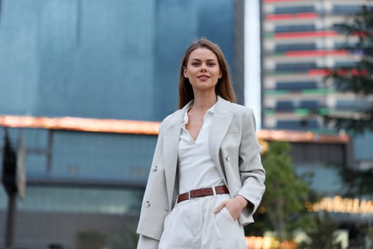 A poised businesswoman dressed in a tailored blazer and trousers, displaying confidence and elegance against a contemporary cityscape, perfect for professional branding and corporate themes.