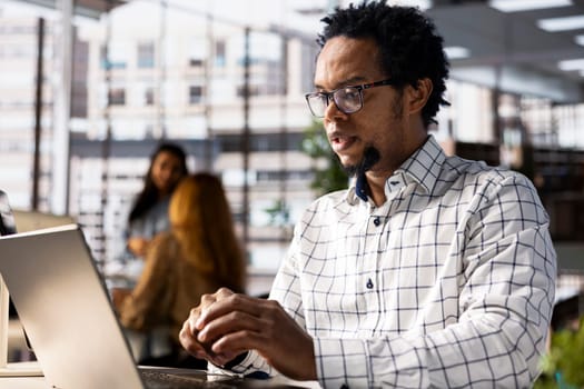 African american entrepreneur attends online meeting to discuss business opportunities and resource allocation. Fostering successful collaboration with the investors group on video conference.