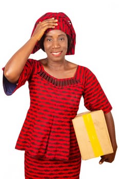 beautiful african adult woman using a mail package making a gesture by putting her hand on her head. on white isolated background