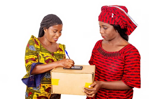 adult delivery service woman in red loincloth and female adult client signing her signature on digital mobile phone receiving mail box package in office