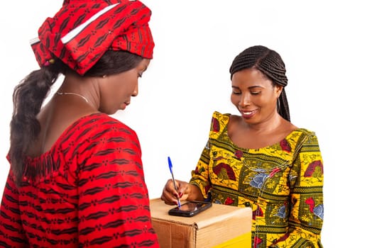 adult delivery service woman in red loincloth and female adult client signing her signature on digital mobile phone receiving mail box package in office