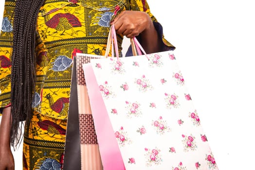 african adult woman holding colorful paper bags