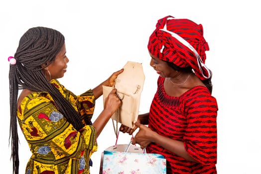 beautiful adult woman wearing a red loincloth holding shopping bags while the other woman opening her handbag