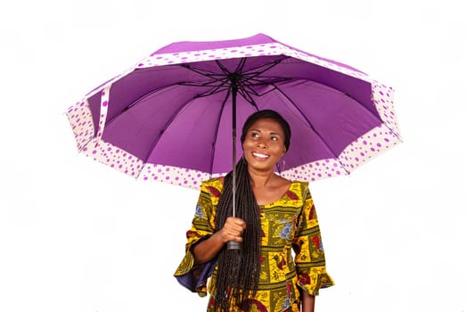 beautiful business women standing under a purple umbrella while being smiling