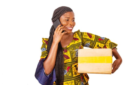 beautiful adult businesswoman talking on the mobile phone holding a cardboard while smiling