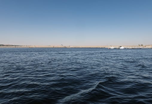 Panorama of Low Aswan Dam, or Old Aswan dam with tourboats used to transport tourists to Philae Temple