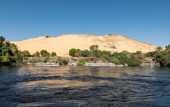 Granite rocks in the fast flowing water of the River Nile near Aswan Egypt