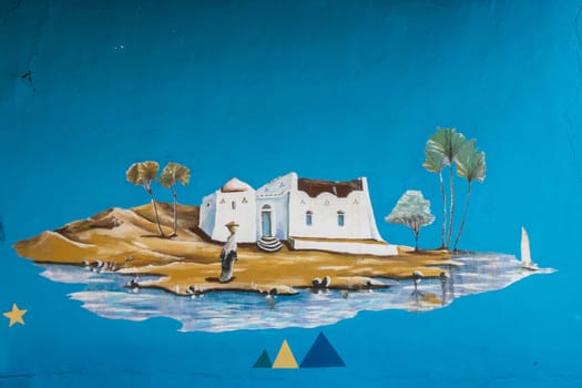 Aswan, Egypt - 5 November 2024: Traditional wall painting on Nubian home near the Nile River in Egypt