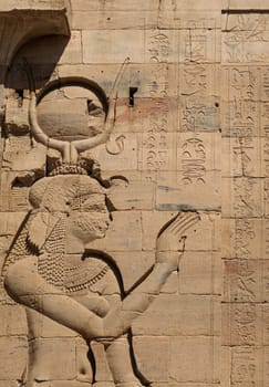 Detail of the bas-relief carving of the goddess Isis in the reconstructed Philae Temple in Aswan Harbor or Reservoir in Egypt