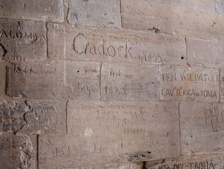 Detail of the names carved by Victorian explorers in Philae Temple in Aswan Harbor or Reservoir in Egypt