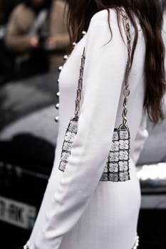 Paris, France - February, 29, 2024: woman wears Rabanne bag, fashion blogger outfit details, street style.