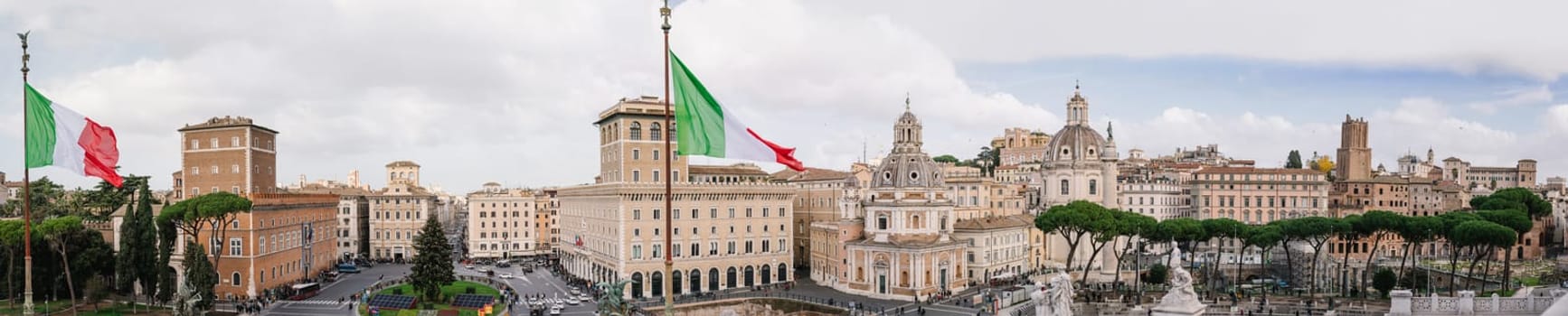 Rome, Italy - 09.12.2022: Panoramic view of historic Rome at Piazza Venezia near Monument to Victor Emmanuel II with italian flags.