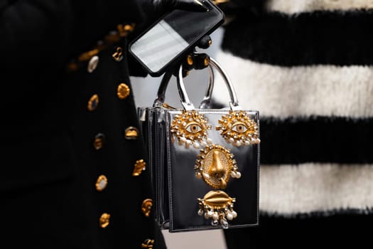 Paris, France - January, 22, 2024: woman wears embroidered jewelry Schiaparelli bag, fashion blogger outfit details, street style