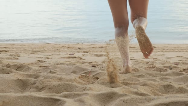 Back view, Young beautiful woman wearing bikini swimsuit running into tropical on sand beach to water, Happy Asian female have fun she run holiday outside, Summer travel vacation concept