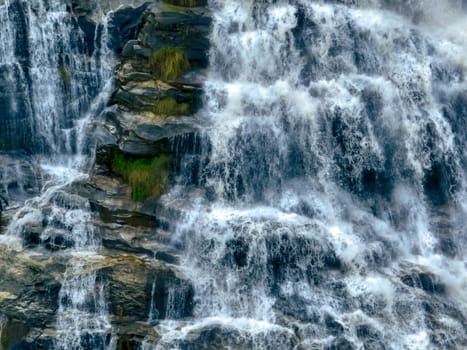 Aerial view of a waterfall in a lush tropical green forest in Doi Inthanon National Park, Chiang Mai, Thailand. This nature landscape showcases water sustainability and scenic travel destinations.