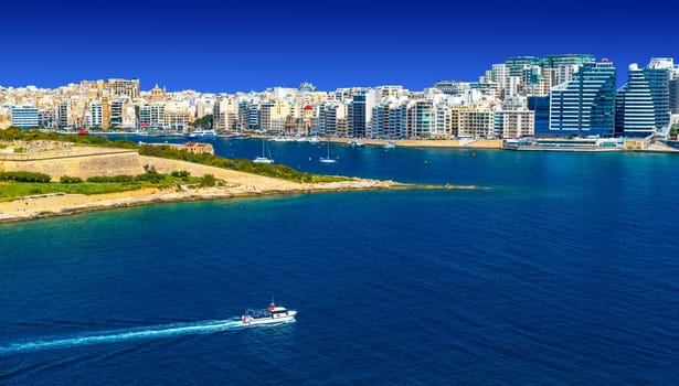 Panoramic view with a ship passing Manoel Island towards Sliema, Malta.