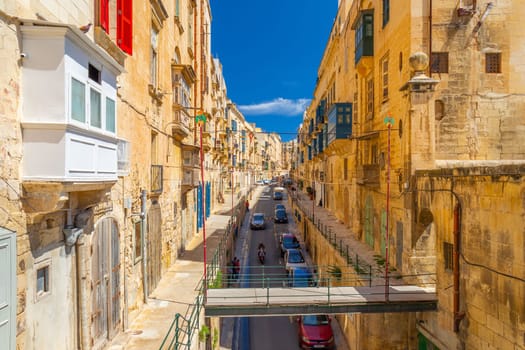Valletta, Malta - April 2, 2025: View of the East Street with metal bridge leading to St Barbara Bastions over Victoria Gate