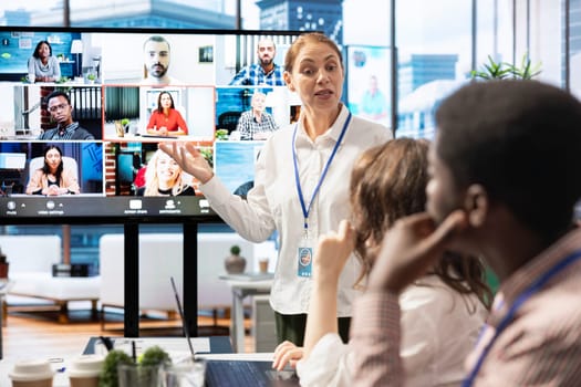 Diverse employees gather to discuss the progress of current projects on videocall, ensuring alignment with the strategic objectives. Management team and workers sharing their innovative ideas.