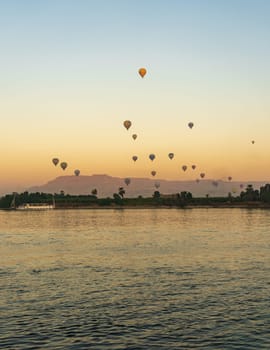 Many balloons in the sky over Nile River in Luxor for sunset flight over the Valley of the Kings