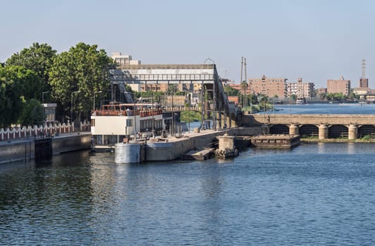 Dahabiha approaches the old dam across Nile and passes through the open lock in Esna