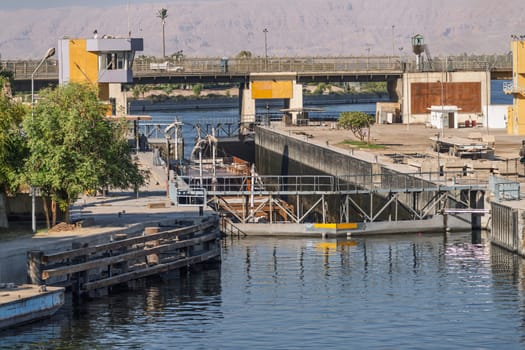 Approaching the new Esna dam and lock on Nile River with dahabiya going through the lock