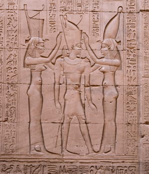 Detail of goddesses greeting pharoah in walls of Edfu Temple near Luxor in Egypt